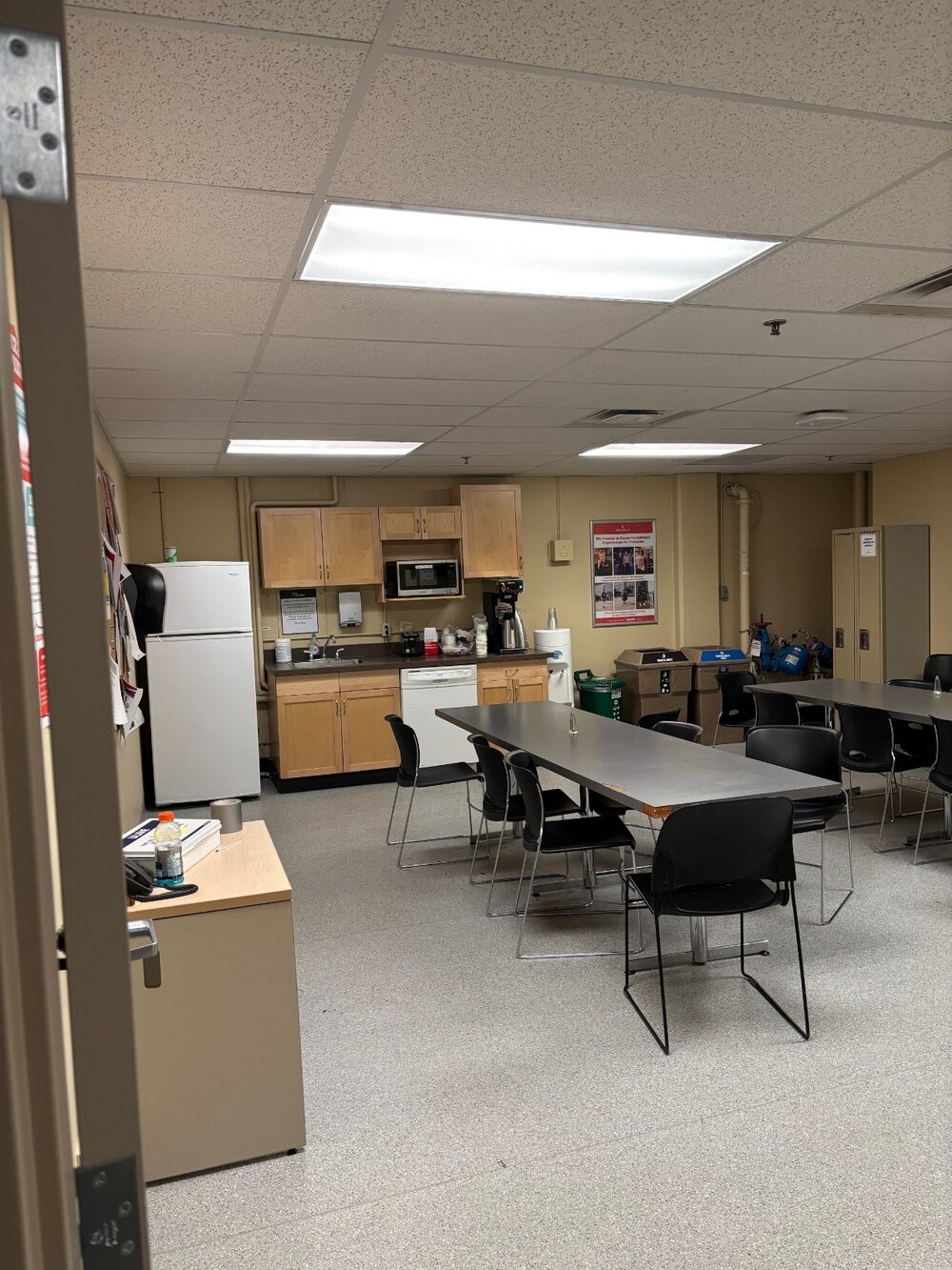 The Big Four employee lunchroom, with a kitchen, tables, and chairs.