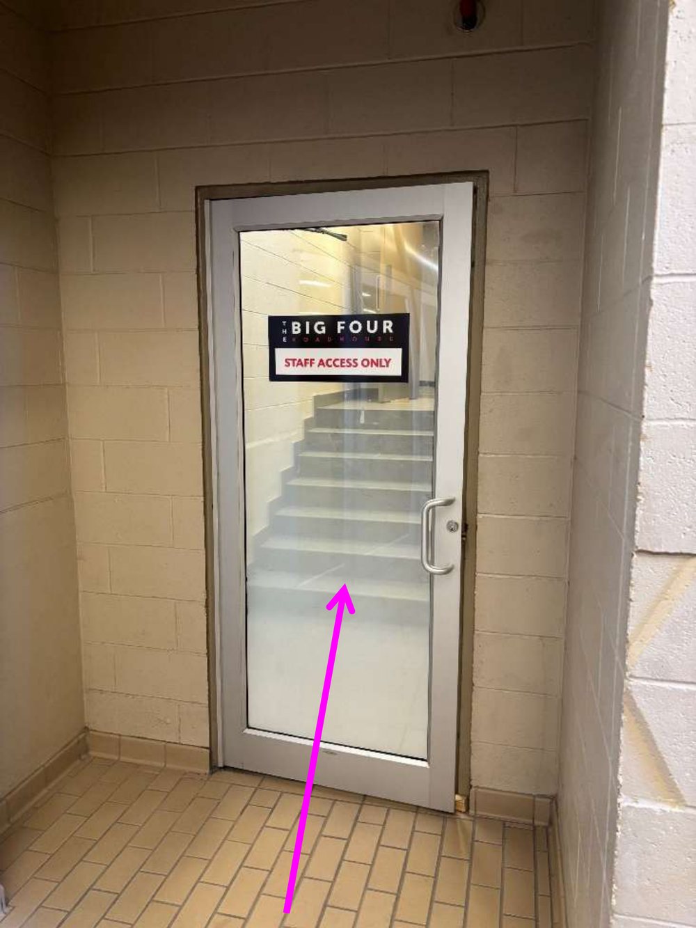 A glass door marked Big Four Roadhouse Staff Access Only, with a stairway behind it.