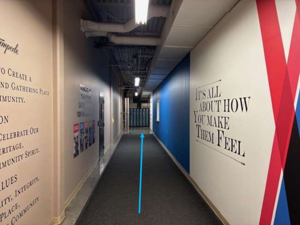 A long Level 2M hallway lined with Stampede values and an arrow pointing straight ahead.