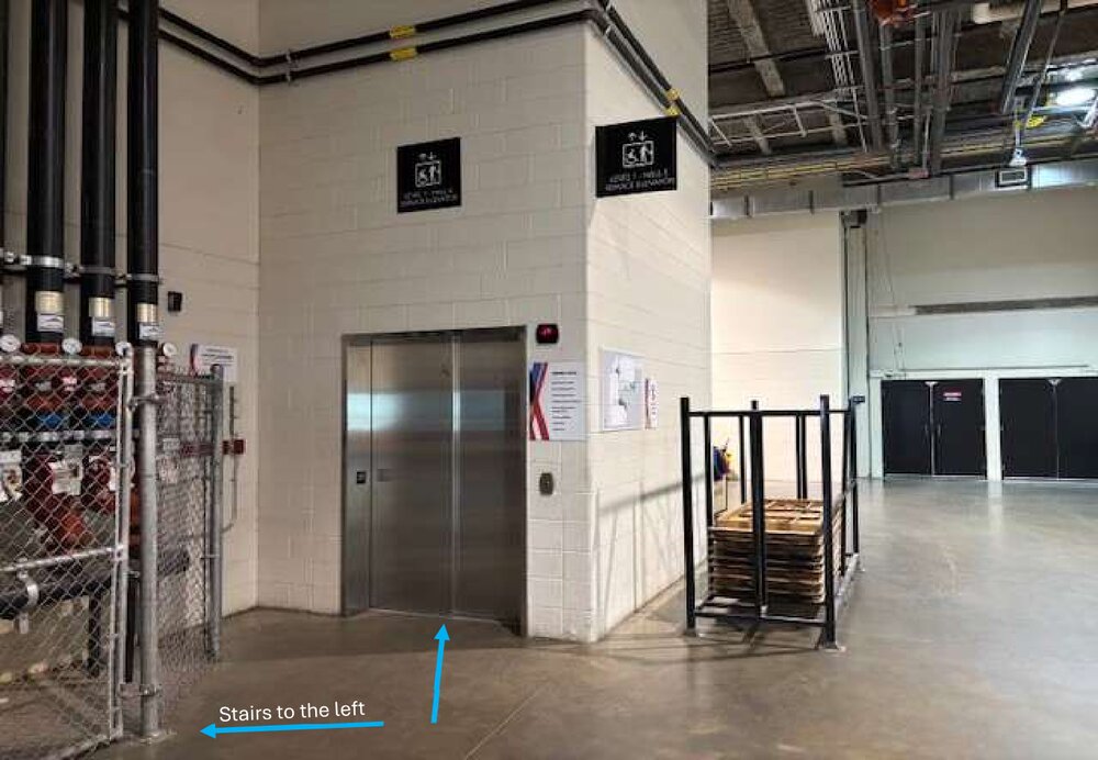 Inside Door 21: an elevator with stairs to the left, both going up to Level 2M.