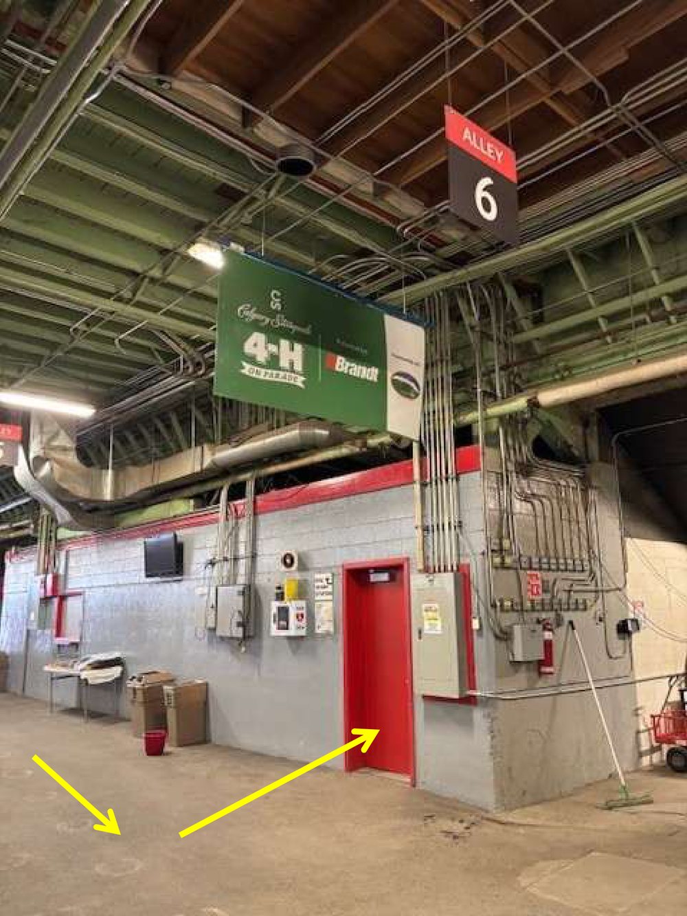 A red door under the Alley 6 sign. This is the AG and NWEC lunchroom entrance.